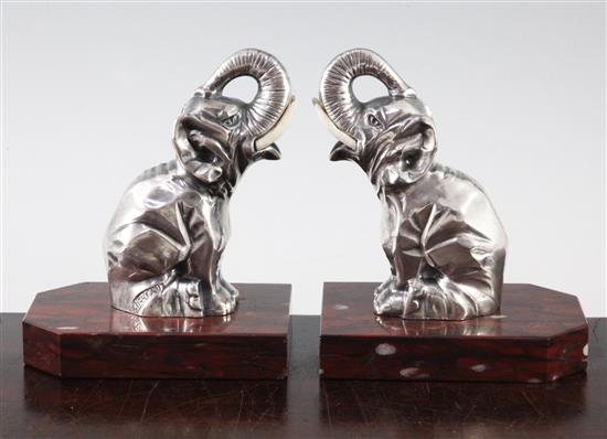 A pair of French Art Deco silvered metal and red marble elephant bookends, 5.5in.